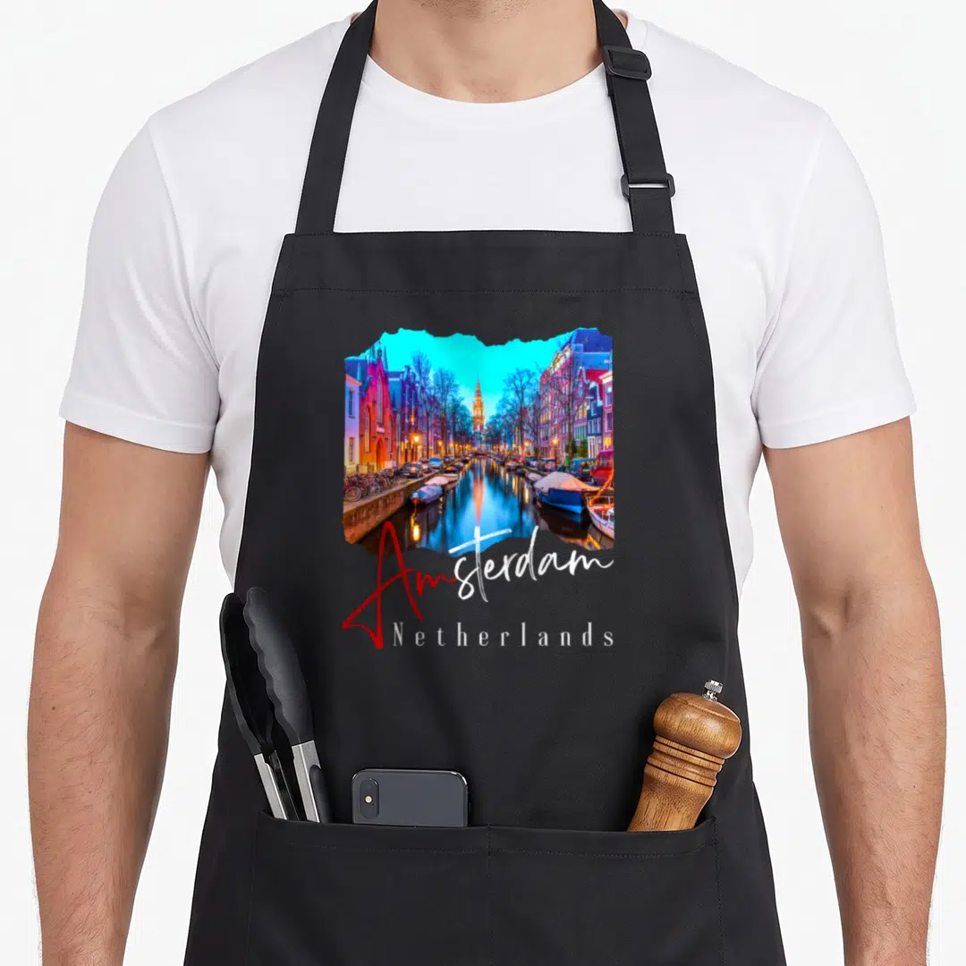 Night amsterdam apron - Canal photo shaped like a map with Amsterdam Netherlands text in blue and red script — shown on a black cotton canvas apron against a white background