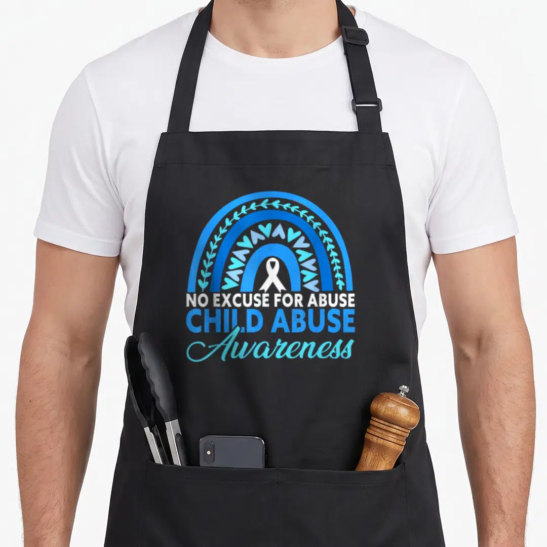 Abuse ribbon apron - Blue rainbow with hearts and white ribbon above NO EXCUSE FOR ABUSE CHILD ABUSE Awareness text — shown on a black cotton canvas apron against a white background