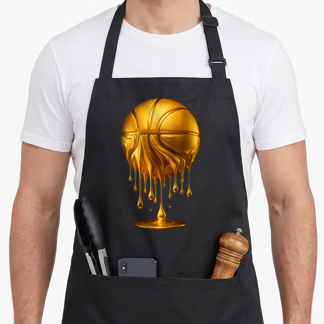 Hoop drip apron - Realistic gold basketball melting into dripping liquid gold pool — shown on a black cotton canvas apron against a white background