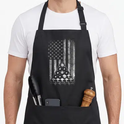 Cue american flag apron - Distressed USA flag background with triangle rack of numbered billiard balls in white and grey — shown on a black cotton canvas apron against a white background