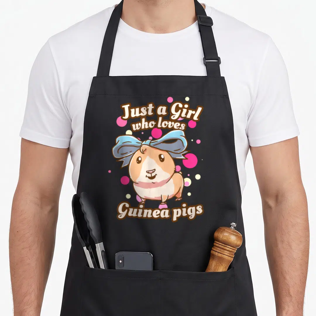Funny pig love guinea apron - Cartoon guinea pig with blue bow and text Just a Girl who loves Guinea pigs surrounded — shown on a black cotton canvas apron against a white background