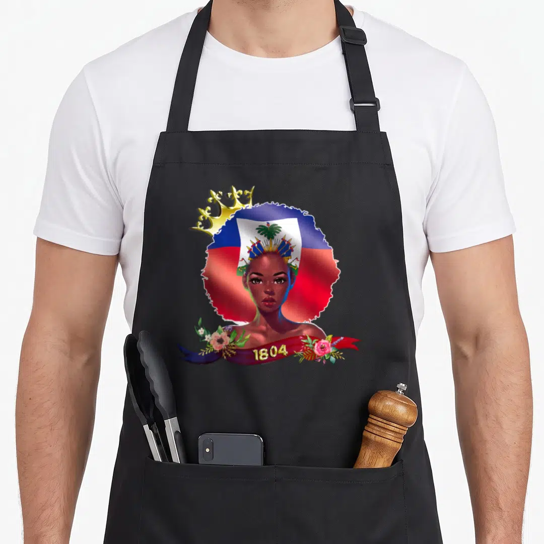 Haitian queen apron - Woman portrait with flag hair gold crown 1804 ribbon flowers — shown on a black cotton canvas apron against a white background