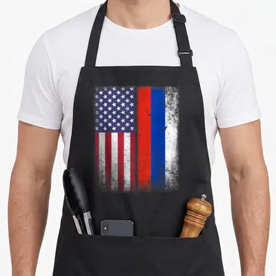 Russian american flag apron - Distressed USA and Russian flags side by side in red white and blue — shown on a black cotton canvas apron against a white background
