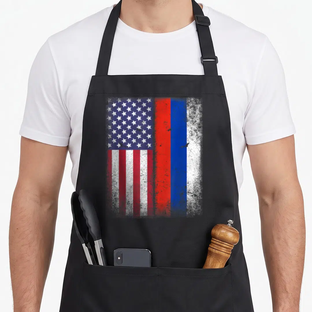 Russian american flag apron - Distressed USA and Russian flags side by side in red white and blue — shown on a black cotton canvas apron against a white background