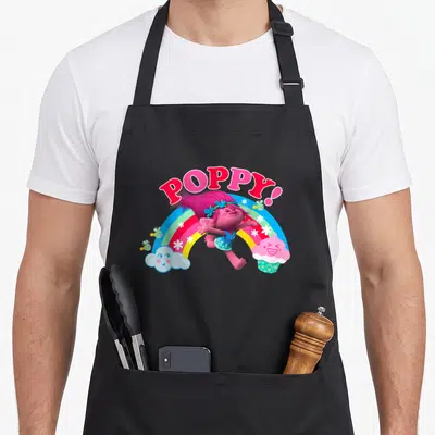 Funny poppy troll apron - POPPY! text over jumping character, rainbow, cloud, cupcake, bees, and flowers — shown on a black cotton canvas apron against a white background