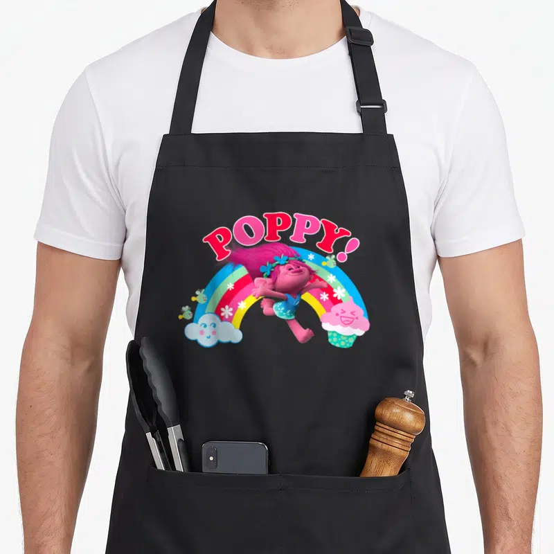 Funny poppy troll apron - POPPY! text over jumping character, rainbow, cloud, cupcake, bees, and flowers — shown on a black cotton canvas apron against a white background