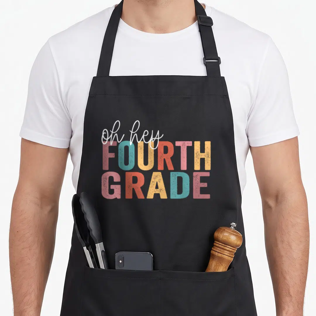Hey fourth teacher apron - Oh hey fourth grade stacked typography in white pink teal yellow orange — shown on a black cotton canvas apron against a white background