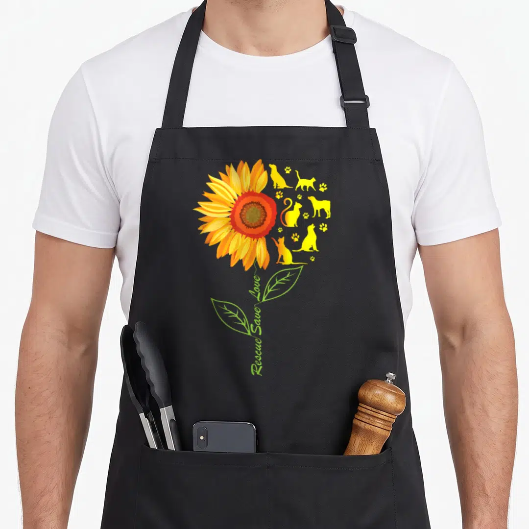 Save animal rescue apron - Sunflower with cat dog silhouettes and vertical Rescue Save Love text — shown on a black cotton canvas apron against a white background