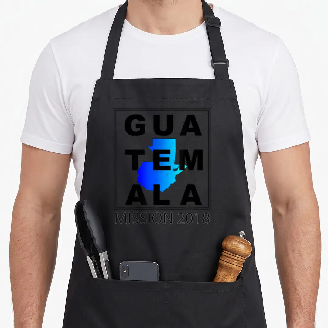 Guatemala mission trip apron - Blue Guatemala map overlapping black GUA TEM ALA text inside a rectangular border above — shown on a black cotton canvas apron against a white background