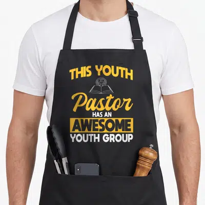 Cute pastor youth apron - Stacked yellow and white text reading THIS YOUTH Pastor HAS AN AWESOME YOUTH GROUP — shown on a black cotton canvas apron against a white background