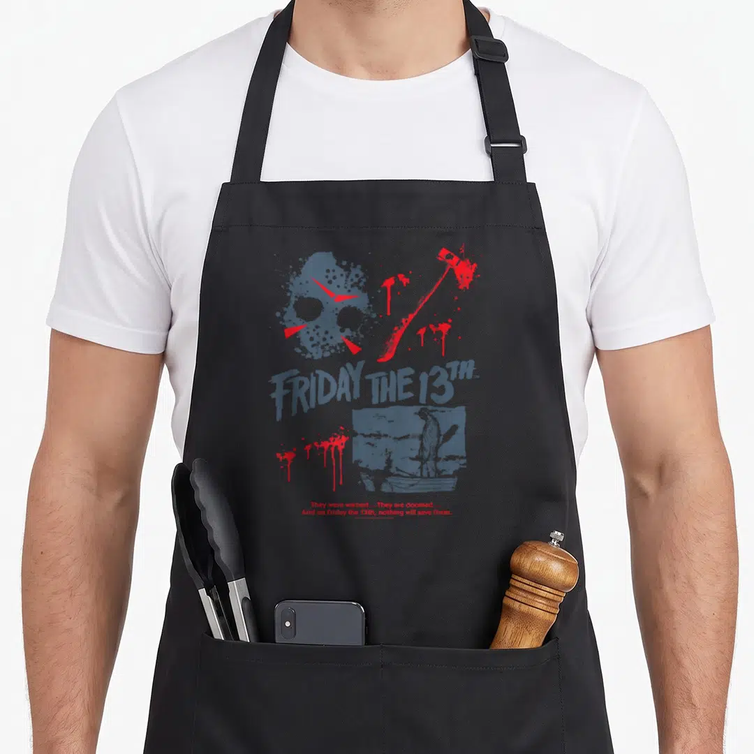 Jason bloody apron - Grey and red distressed hockey mask axe and boat scene with tagline text — shown on a black cotton canvas apron against a white background