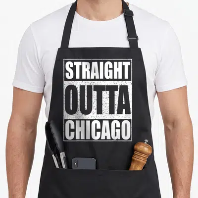Straight chicago apron - Stacked white and grey distressed text reading STRAIGHT OUTTA CHICAGO inside a rectangular — shown on a black cotton canvas apron against a white background