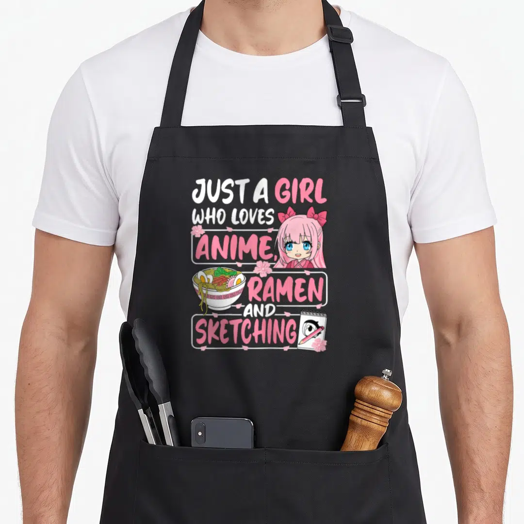 Anime ramen japan apron - Anime girl, ramen bowl, sketchbook, pink text boxes, cherry blossoms — shown on a black cotton canvas apron against a white background