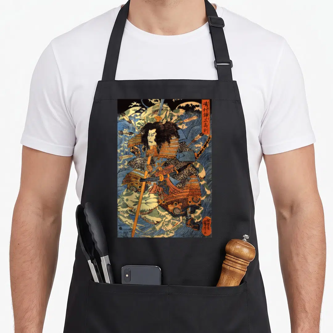 Japanese crab apron - Samurai in blue and orange armor holding a spear amid crashing waves with vertical Japanese text — shown on a black cotton canvas apron against a white background