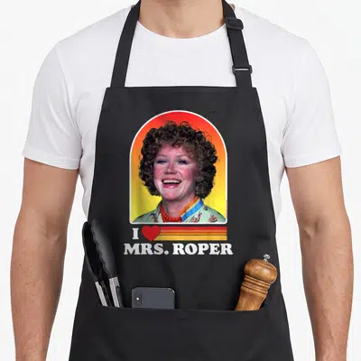 Roper mrs apron - Photo of woman in arched frame with I heart Mrs Roper text and red orange stripes — shown on a black cotton canvas apron against a white background