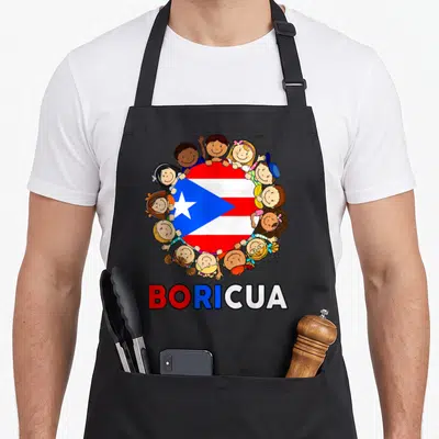 Puerto rico hispanic aprons - Cartoon children surrounding a circular Puerto Rican flag with the word Boricua printed — shown on a black cotton canvas apron against a white background