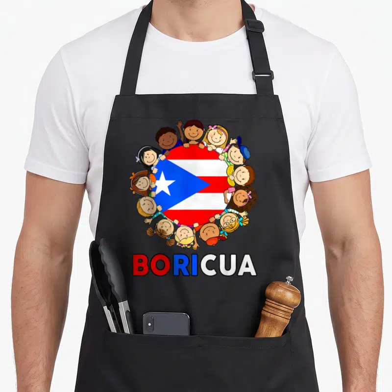 Puerto rico hispanic aprons - Cartoon children surrounding a circular Puerto Rican flag with the word Boricua printed — shown on a black cotton canvas apron against a white background
