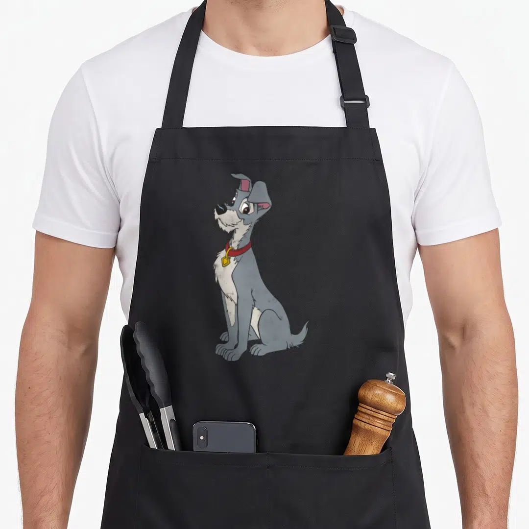 Simple portrait lady and the tramp apron - Grey cartoon dog sitting with red collar and yellow tag — shown on a black cotton canvas apron against a white background
