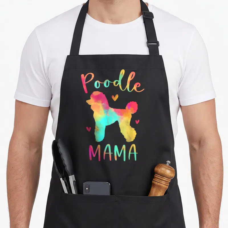 Poodle mama dog apron - Watercolor poodle silhouette in pink blue yellow orange with three hearts and Poodle MAMA text — shown on a black cotton canvas apron against a white background