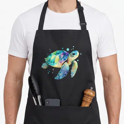 Turtle splash aprons - Watercolor sea turtle with blue, green, yellow, purple, pink bubbles — shown on a black cotton canvas apron against a white background