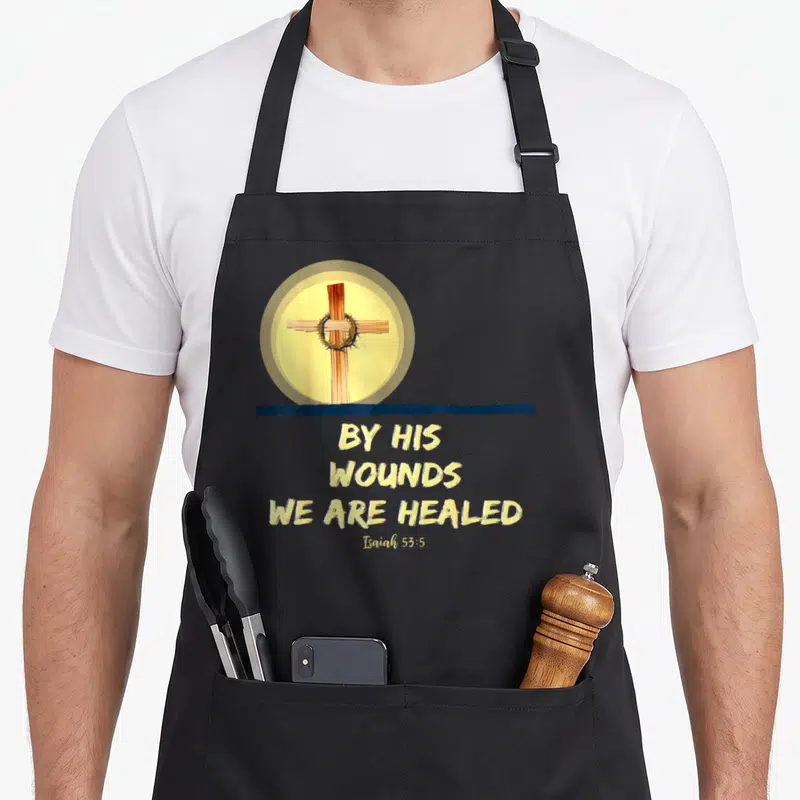 His christian apron - Realistic cross with crown of thorns inside yellow circle above yellow text on dark blue line — shown on a black cotton canvas apron against a white background