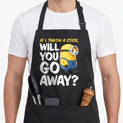 Away novelty apron - Stacked text reading IF I THROW A STICK WILL YOU GO AWAY next to a standing yellow minion in blue — shown on a black cotton canvas apron against a white background