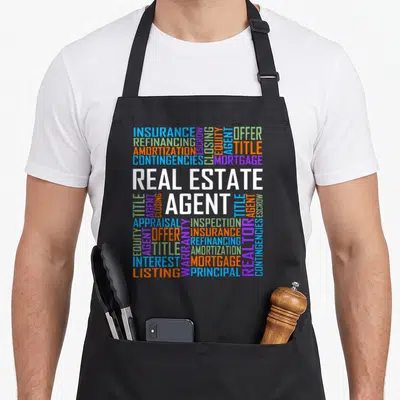 Proud agent apron - Real Estate Agent word cloud with insurance mortgage and closing terms in blue orange purple — shown on a black cotton canvas apron against a white background