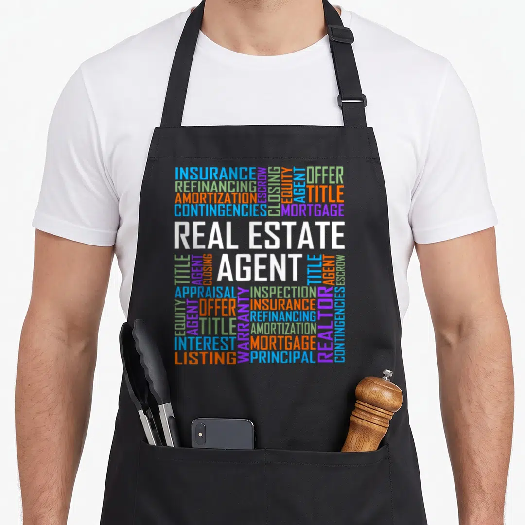 Proud agent apron - Real Estate Agent word cloud with insurance mortgage and closing terms in blue orange purple — shown on a black cotton canvas apron against a white background