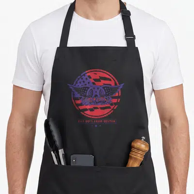 Aerosmith boston smith rock apron - Red and purple circular flag with wings and Bad Boys from Boston text below three — shown on a black cotton canvas apron against a white background