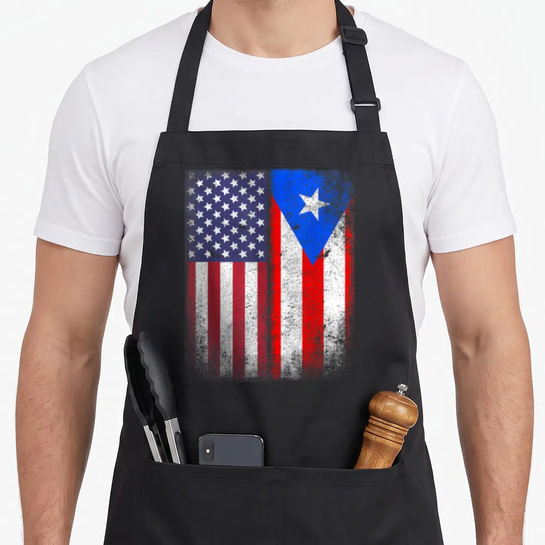 Rico american flag apron - Two distressed flags in red white and blue side by side — shown on a black cotton canvas apron against a white background