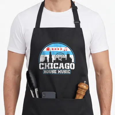 Music skyline chicago apron - Retro blue skyline with ferris wheel, red icons, and stacked CHICAGO HOUSE MUSIC text — shown on a black cotton canvas apron against a white background