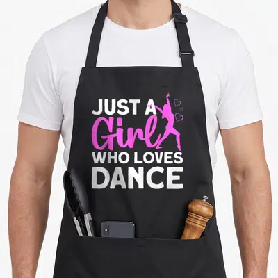 Dancing hip apron - White and pink text Just A Girl Who Loves Dance with dancer silhouette and three hearts — shown on a black cotton canvas apron against a white background