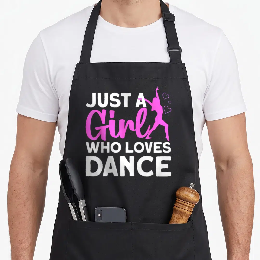 Dancing hip apron - White and pink text Just A Girl Who Loves Dance with dancer silhouette and three hearts — shown on a black cotton canvas apron against a white background