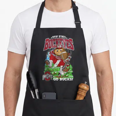 Brutus football apron - Cartoon Brutus Buckeye running with football surrounded by red white and green text — shown on a black cotton canvas apron against a white background