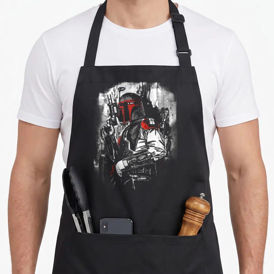 Stare black officially apron - Grey red and white splatter portrait of armored character holding weapon — shown on a black cotton canvas apron against a white background