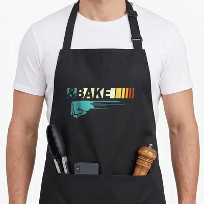 Bake family aprons - Teal fist and vertical stripes below &BAKE text — shown on a black cotton canvas apron against a white background