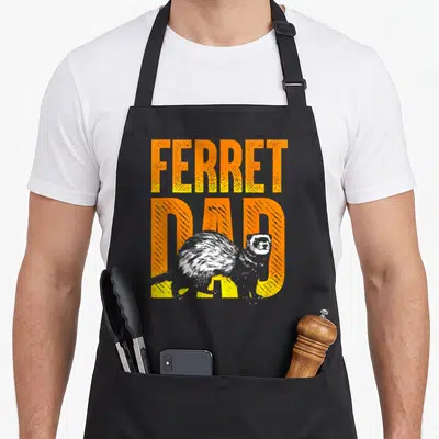 Animal father day apron - Distressed orange and yellow FERRET DAD text with a grey and white realistic ferret — shown on a black cotton canvas apron against a white background