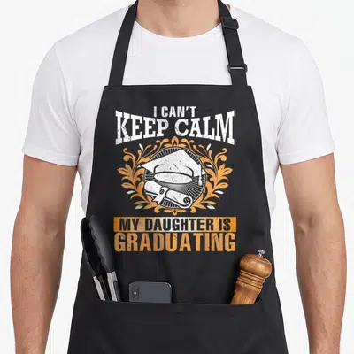 Graduating mom daughter apron - I Can't Keep Calm My Daughter Is Graduating text with cap and diploma in distressed — shown on a black cotton canvas apron against a white background