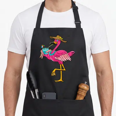 Summer pink flamingo apron - Cartoon pink flamingo wearing brown hat and blue lei holding blue drink with umbrella — shown on a black cotton canvas apron against a white background