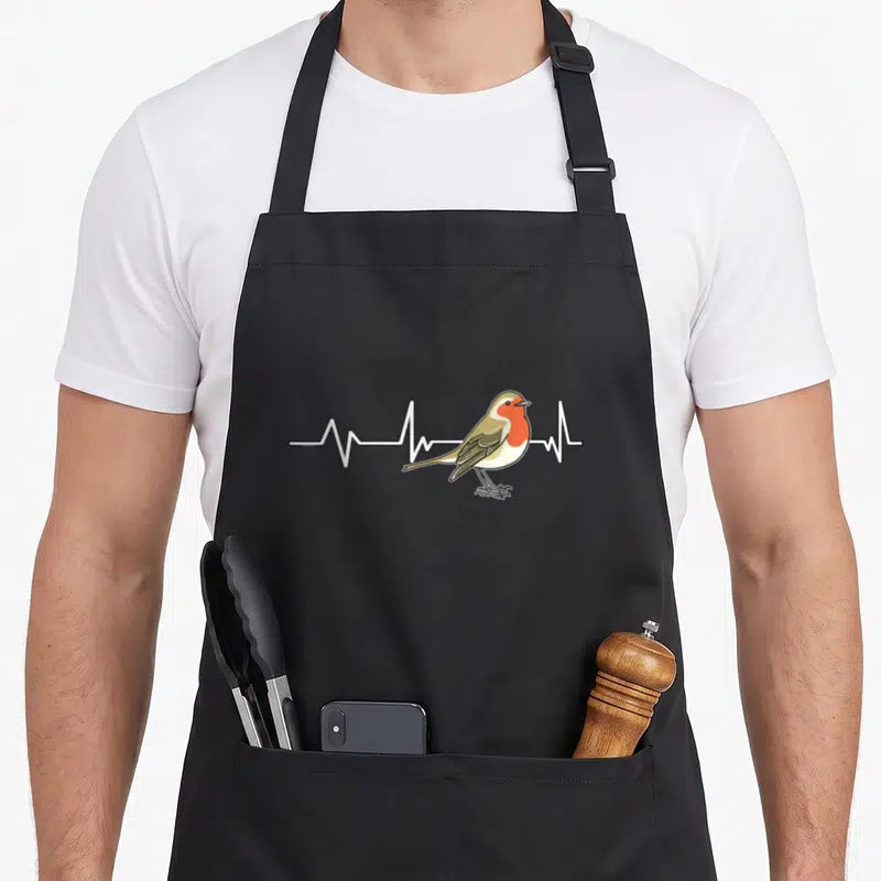 Robin heartbeat bird apron - Cartoon robin with orange breast over white EKG line on brown wings — shown on a black cotton canvas apron against a white background