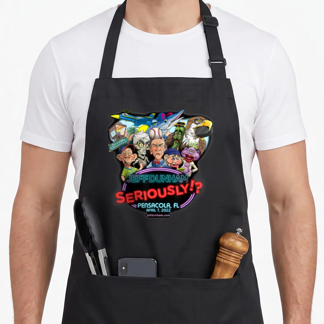 Jeff pensacola apron - Jeff Dunham caricatures, jet, marlin, Seville Quarter sign, and neon Seriously text — shown on a black cotton canvas apron against a white background