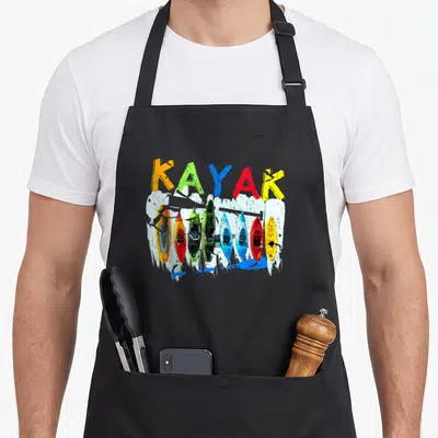 Kayaking canoeing apron - KAYAK text in orange green blue red yellow above seven top-down kayaks on white splash — shown on a black cotton canvas apron against a white background