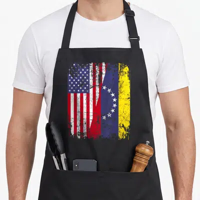 Venezuelan american flag apron - Distressed Venezuelan and American flags merging in red white blue and yellow — shown on a black cotton canvas apron against a white background