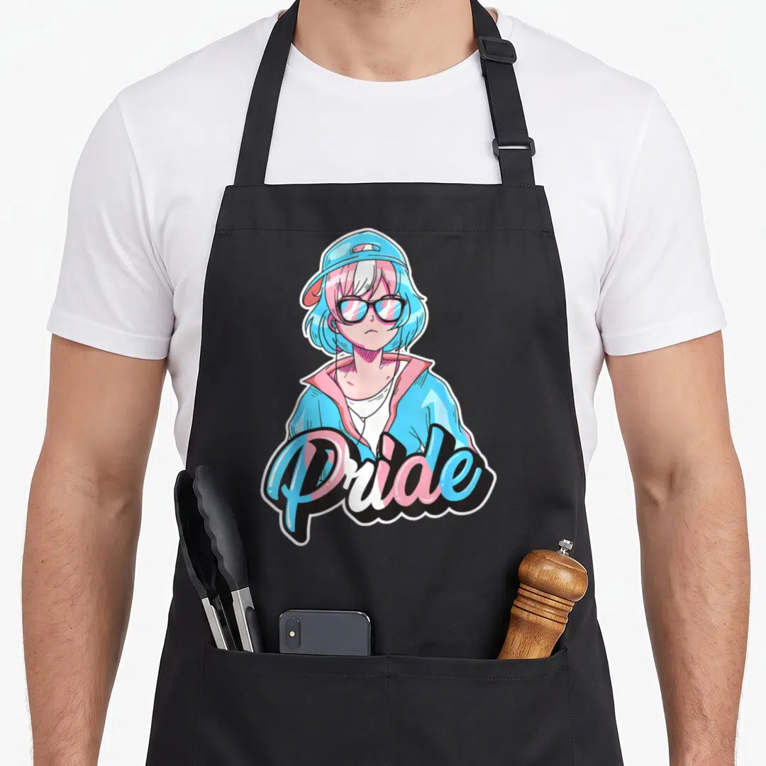 Pride anime apron - Cartoon anime person with glasses and Pride text in trans flag colors — shown on a black cotton canvas apron against a white background