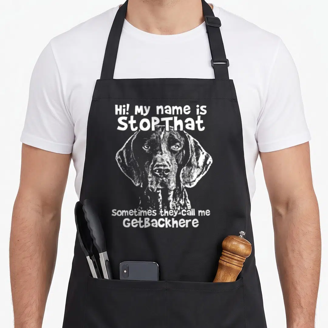 Stopthat pointer apron - White line art dog head centered between text reading Hi My Name Is StopThat and Sometimes — shown on a black cotton canvas apron against a white background