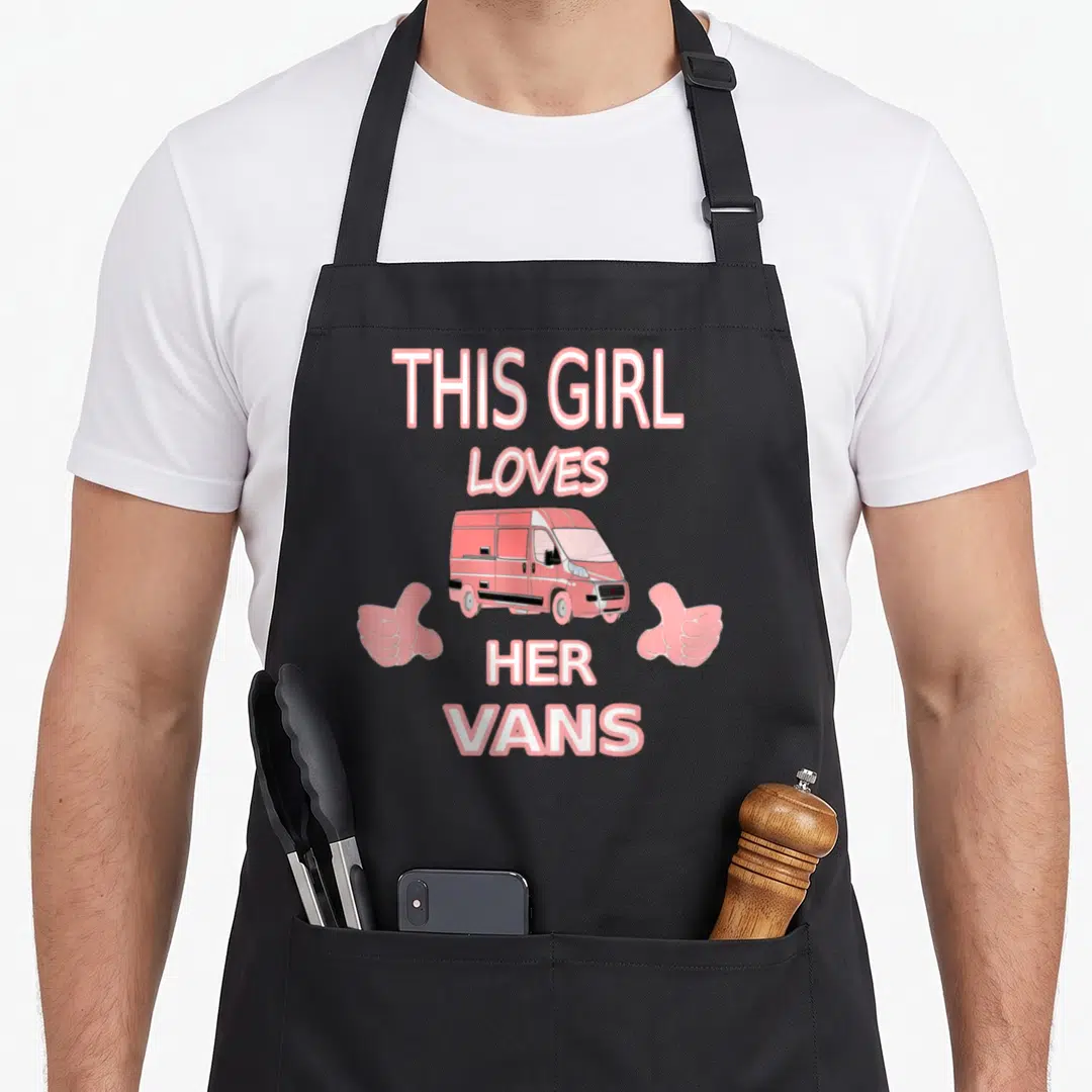 Ride motorhome girl apron - Pink van with thumbs up hands and text This Girl Loves Her Vans — shown on a black cotton canvas apron against a white background