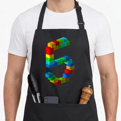 5th building aprons - Number 5 formed from red yellow green blue and orange toy blocks — shown on a black cotton canvas apron against a white background