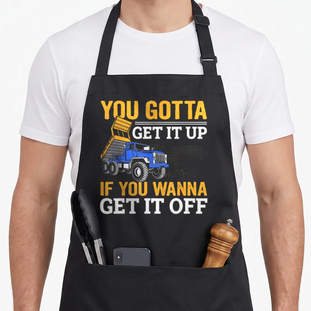 Trucking dump truck apron - Blue dump truck with raised bed and You Gotta Get It Up If You Wanna Get It Off text — shown on a black cotton canvas apron against a white background