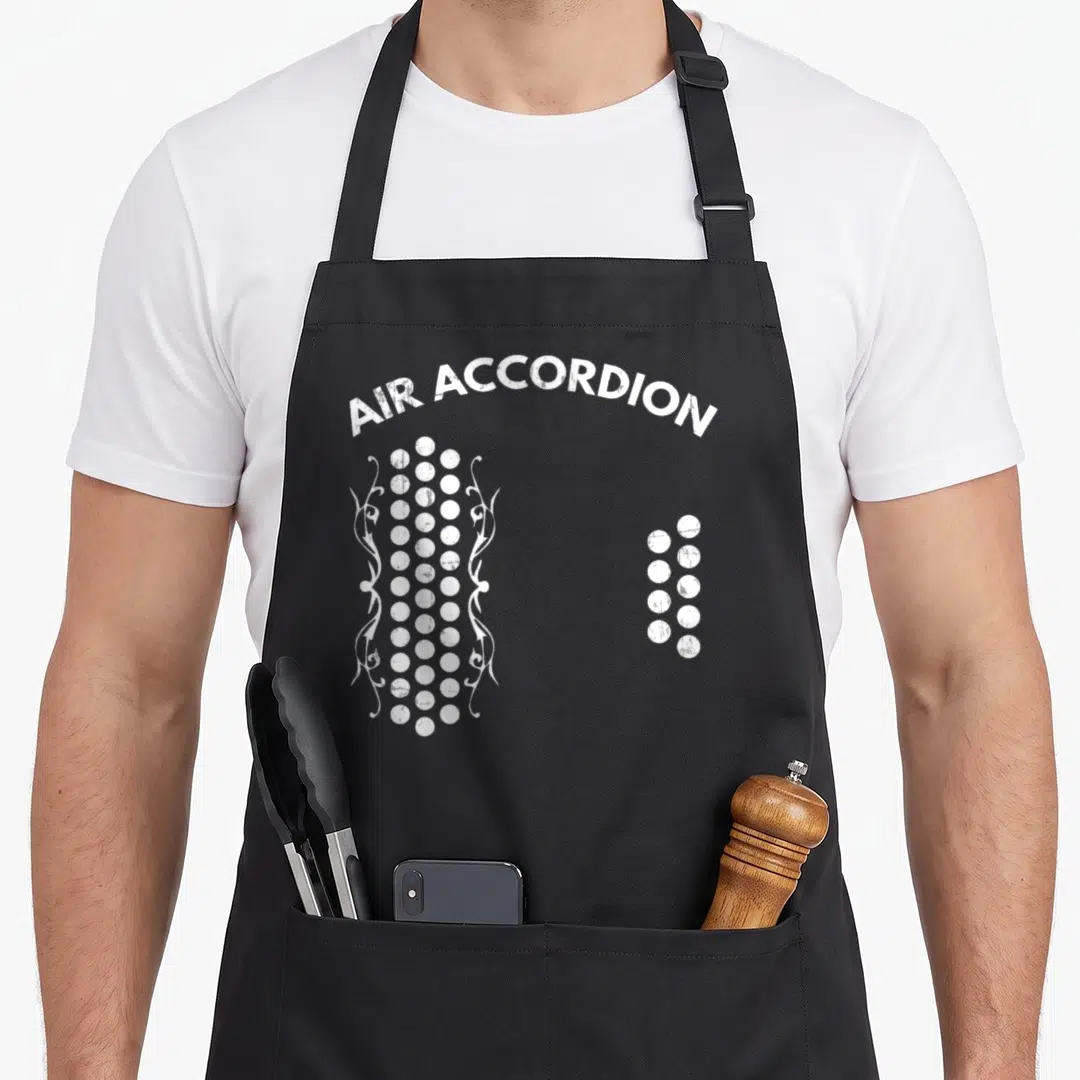 Air accordion apron - Arched distressed text above two clusters of white circles flanked by swirls — shown on a black cotton canvas apron against a white background