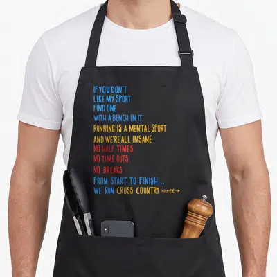 Run country apron - Stacked blue yellow and red running quote typography with arrows — shown on a black cotton canvas apron against a white background